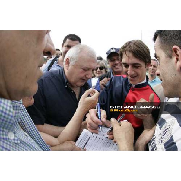 Christophe Soumillon signs autographs after winning with Dionisia the Oaks d\'Italia Milan, 18th june 2006 ph. Stefano Grasso