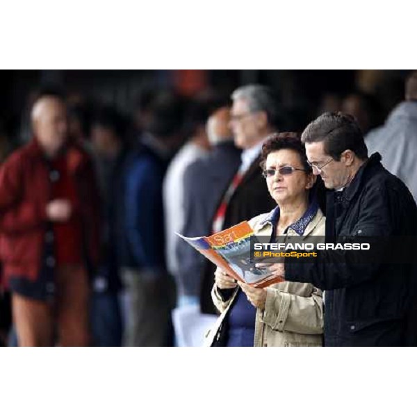 racegoers study the form at San Siro trotting racetrack Milan, 25th april 2009 ph. Stefano Grasso