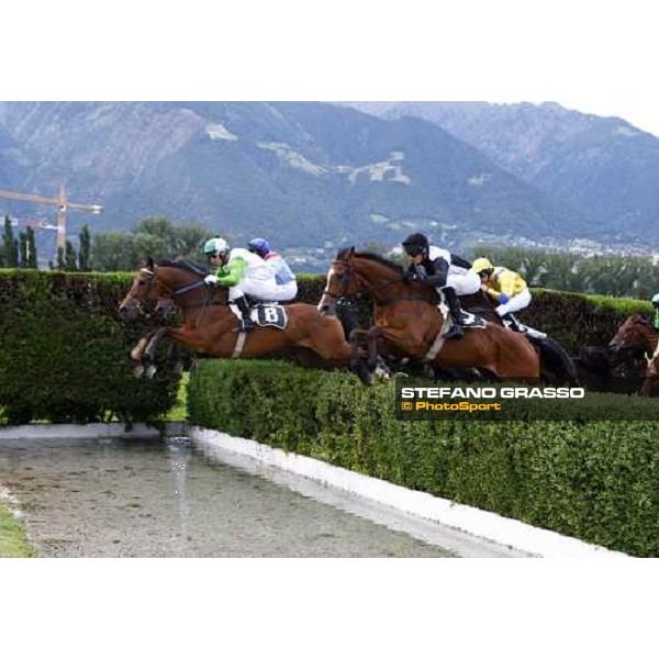 Raffaele Romano on Sharstar jumps the water jump and goes to win the 1¡ Grande Steeple-Chase d\' Europa - close to him Nikodem Merano, 21st june 2009 ph. Stefano Grasso