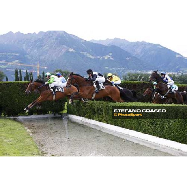Raffaele Romano on Sharstar jumps the water jump and goes to win the 1¡ Grande Steeple-Chase d\' Europa - close to him Nikodem Merano, 21st june 2009 ph. Stefano Grasso