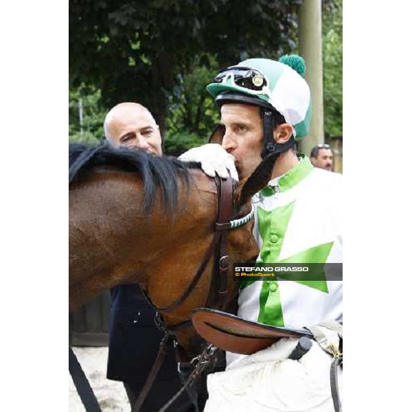 a kiss to Sharstar by Raffaele Romano in the winner circle of the 1¡ Grande Steeple-Chase d\' Europa Merano, 21st june 2009 ph. Stefano Grasso
