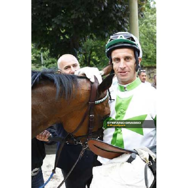 a caress to Sharstar by Raffaele Romano in the winner circle of the 1¡ Grande Steeple-Chase d\' Europa Merano, 21st june 2009 ph. Stefano Grasso