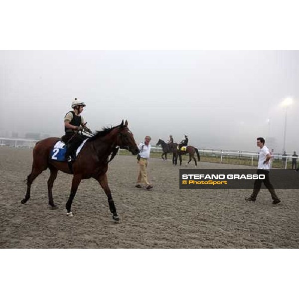 Luca and Matteo Cumani watching Summit Surge after a canter with Presvis in the back Dubai - Meydan, 25th march 2010 ph. Stefano Grasso