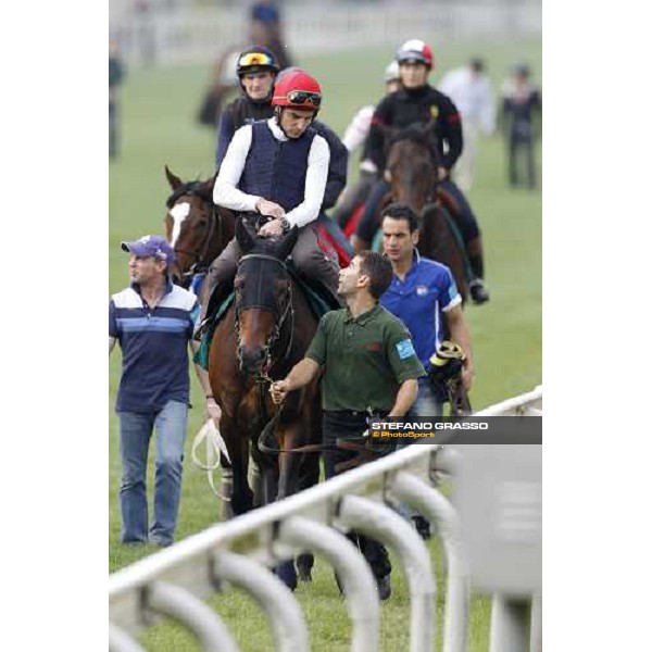 Morning track works at Sha Tin racecourse - Endo Botti on Jakkalberry leads a group of horses going to the morning worksout Hong Kong- Sha Tin, 10th dec. 2010 ph. Stefano Grasso