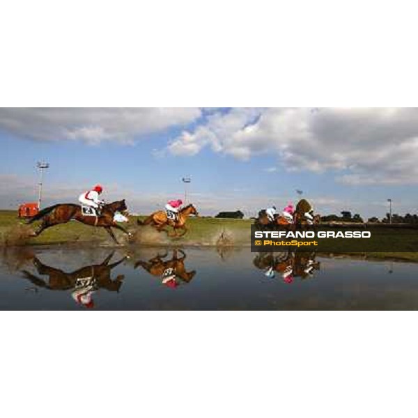 the horses of the 122¡ Grande Steeple Chase di Roma - Memorial Gen. Mario Argenton go trough the lake during the race - the winners Dirk Furhmann and St Petersbourg, in the leading group with blue jacket. Rome Capannelle racetrack, 12th febr. 2011 ph