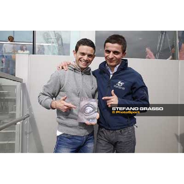 Umberto Rispoli and Andrea Atzeni with the book \'Laghat\' by Enrico Querci Hong Kong - Sha Tin racecourse,12/12/2014 ph.Stefano Grasso