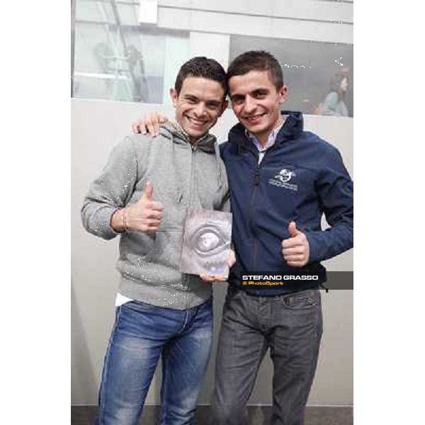 Umberto Rispoli and Andrea Atzeni with the book \'Laghat\' by Enrico Querci Hong Kong - Sha Tin racecourse,12/12/2014 ph.Stefano Grasso
