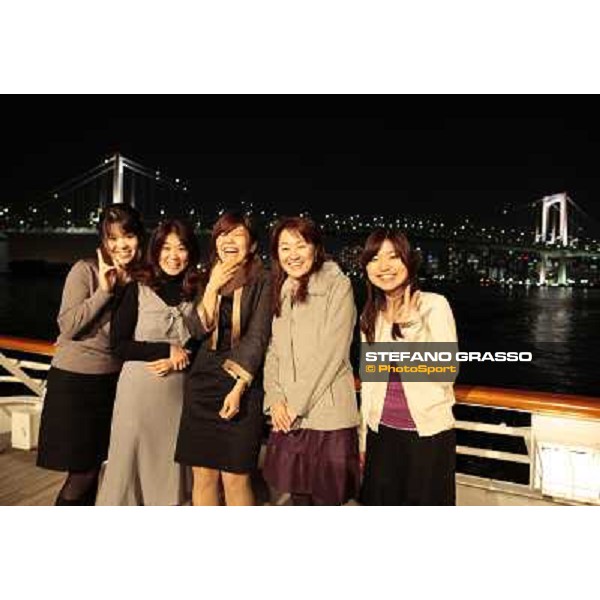 a group of Japanese girls smiling for the photographer during the dinner cruise party by JRA in Tokyo Bay. Tokyo, 26th nov. 2009 ph. Stefano Grasso