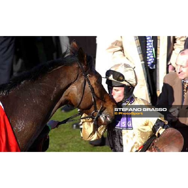 Graham Lee kisses Inglish Drever in the winner circle after winning the Ladbrokes World Hurdle Race - at right the owner mr. Graham Wylie Cheltenham - The Festival 3rd day , 17th march 2005 ph. Stefano Grasso